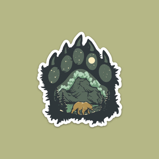 Bear walking in front of mountain nature scene